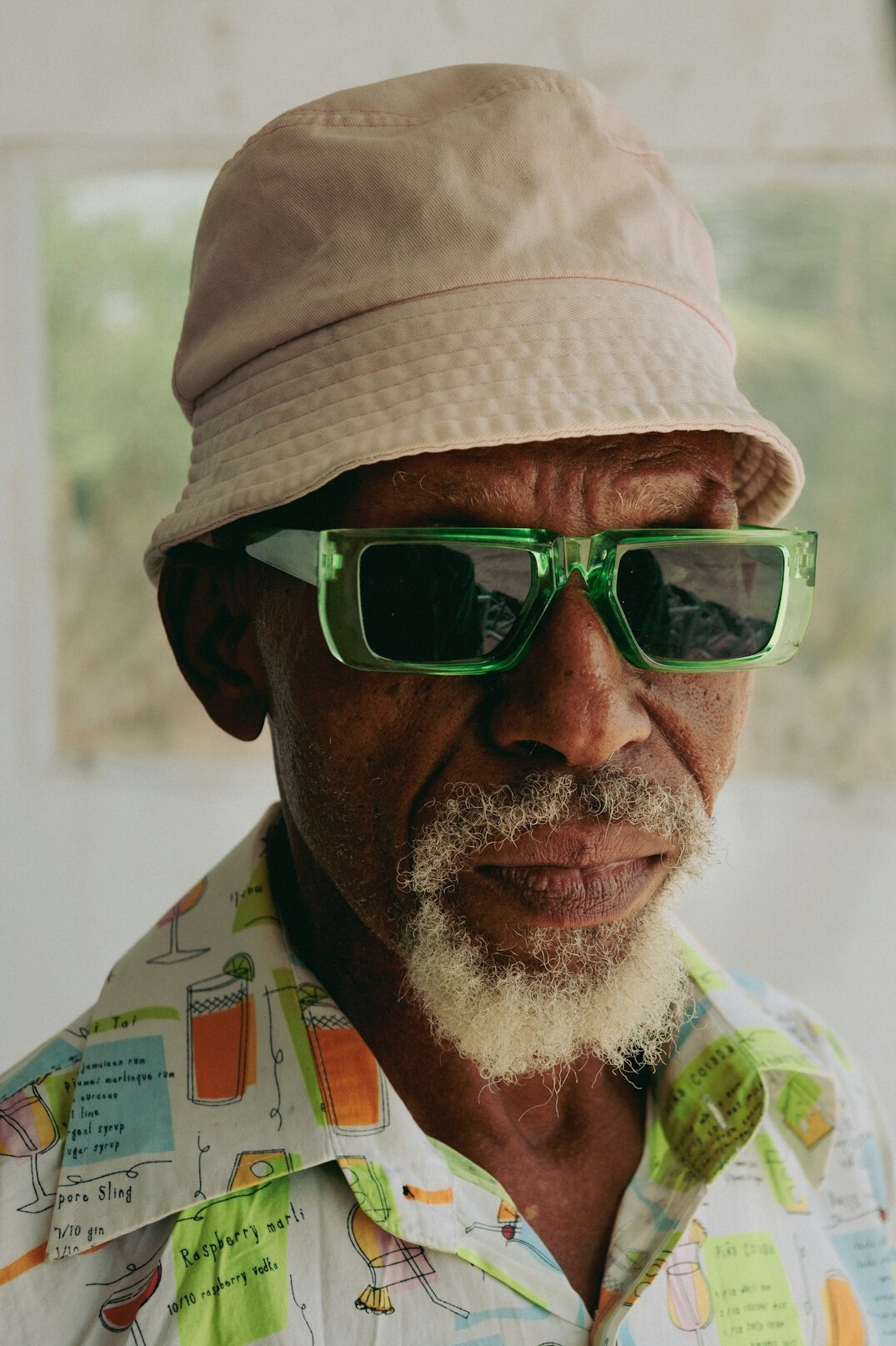 Studio portrait of a Brazilian man with glasses and a calm expression