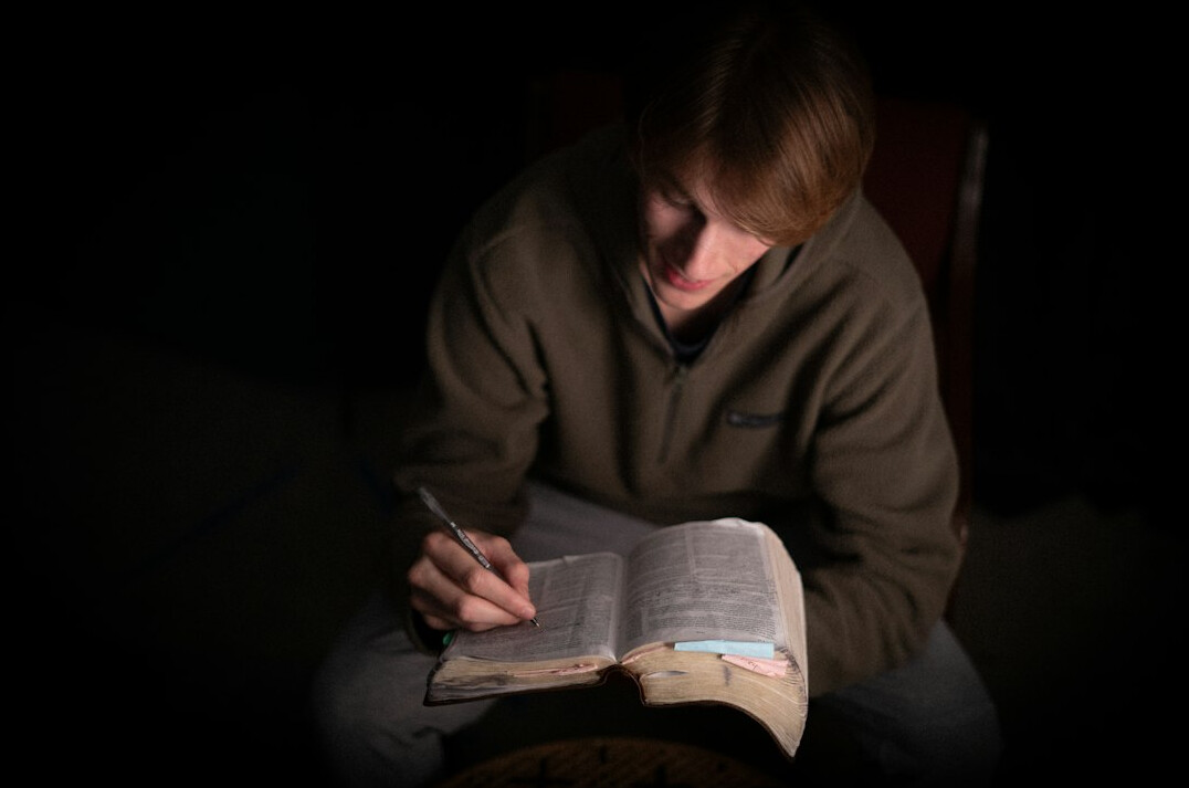 person reading book in quiet room