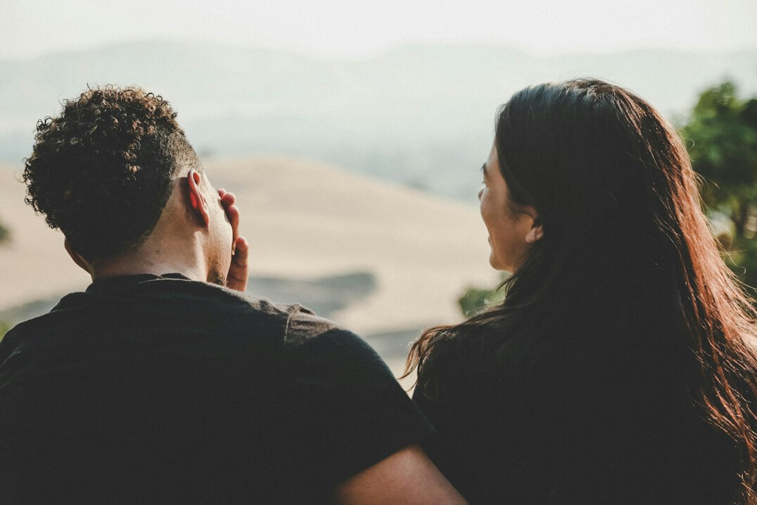 Brazilian man and woman having a respectful discussion at a table