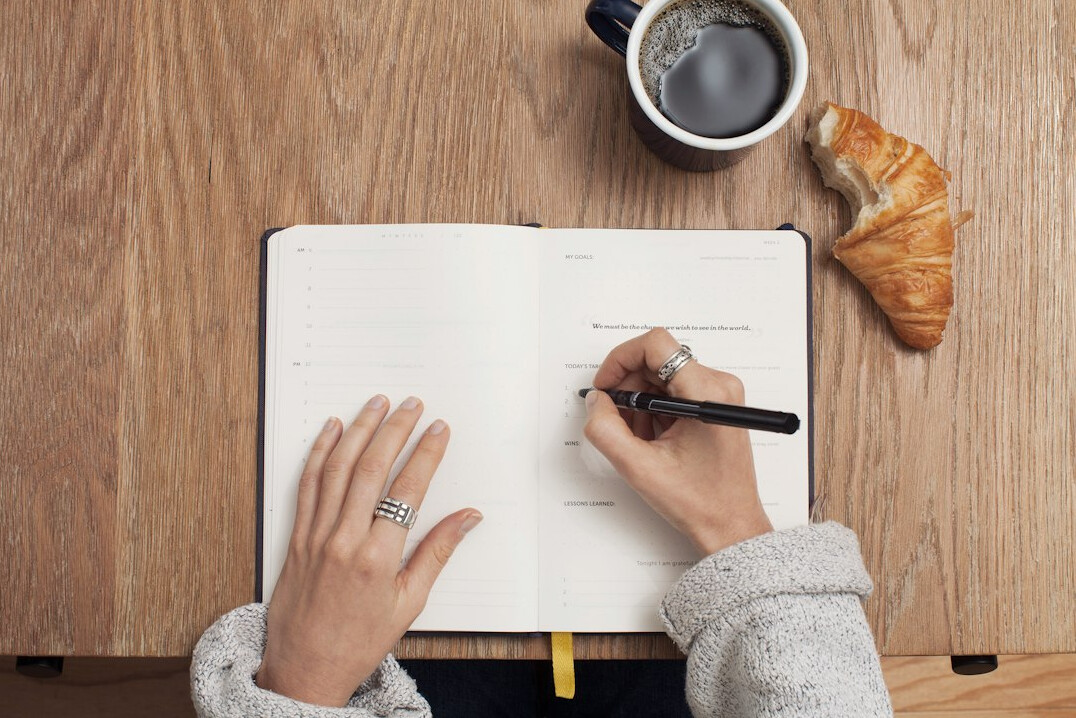 person drawing in journal