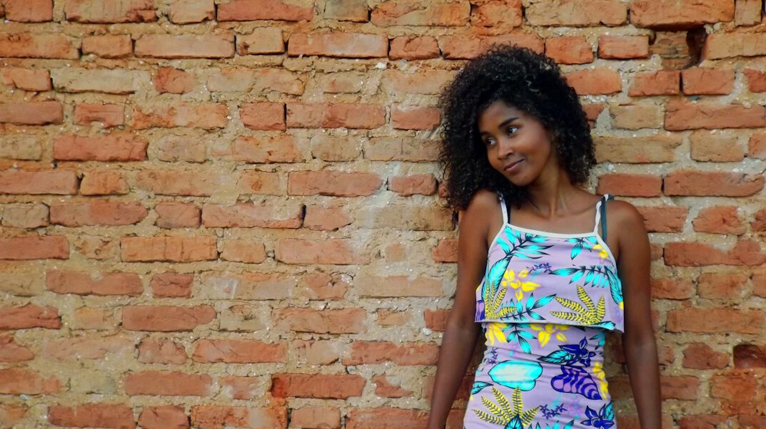 Studio portrait of a Brazilian woman with straight hair and a confident smile