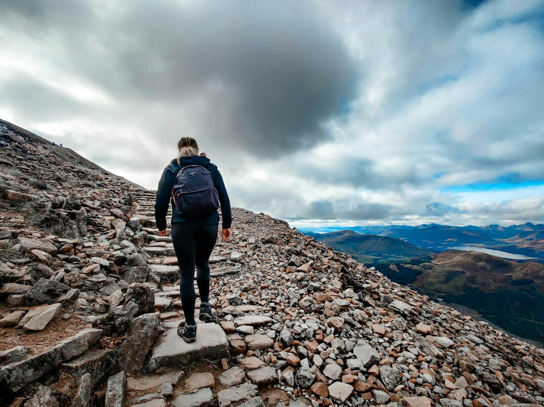 person climbing mountain path