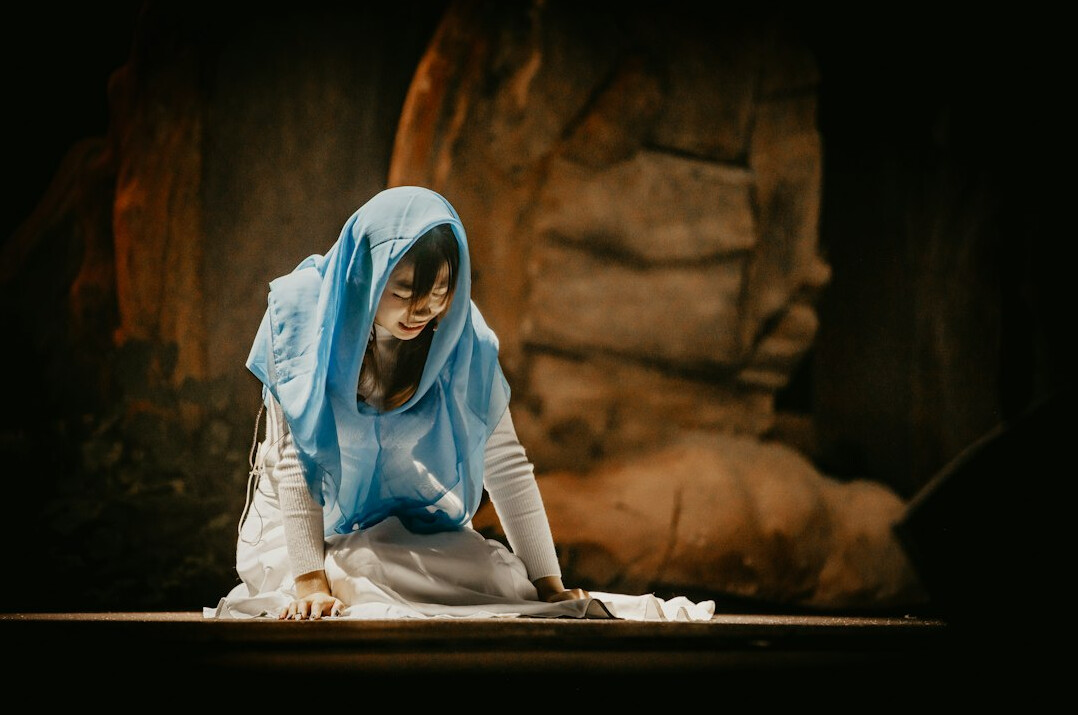 Brazilian woman smiling while writing a letter at a wooden table